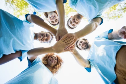 group of volunteer forming huddles